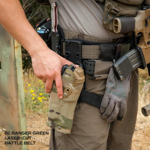 Person wearing a B1 Ranger Green laser-cut battle belt with tactical gear in an outdoor setting.