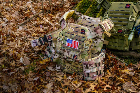 Tactical plate carrier vests from The Malinois Collection displayed outdoors, designed for durability and comfort in high-stress environments
