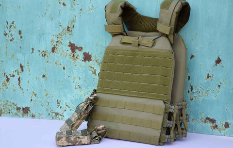 Image of Tactical Military Body Armor with Plates Against Rusty Fence Background