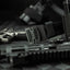 Close-up of tactical Kore battle belt including a gun and magazine on a dark surface.