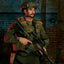 Person in tactical gear holding a rifle against a brick wall background