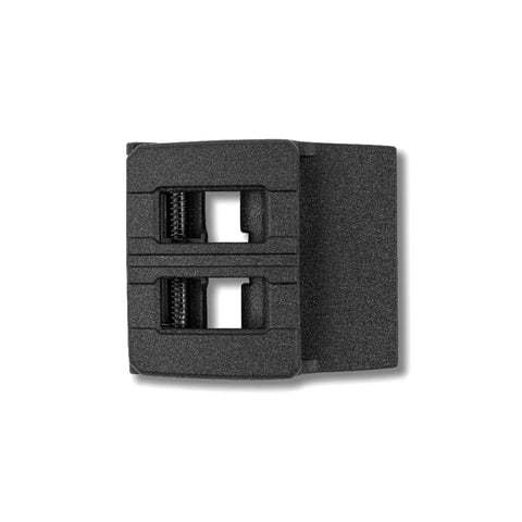 Close-up of a Kore belt buckle on a white background.