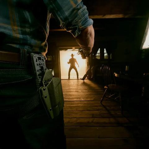 Person with tactical gear entering a dimly lit room with a bright light source.